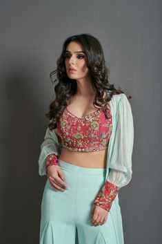 This sea green 3 piece georgette crepe set includes a sheer jacket with contrasting red embroidered cuffs and flare pants.  It is paired with a magnificent printed crimson red embellished crop top. Crop Top With Plazo And Jacket, Top With Palazzo Pants, Crop Top With Palazzo, Top With Palazzo, Top And Plazo, Ruffle Dupatta, Embellished Crop Top, Indian Outfits Lehenga, Traditional Blouse Designs