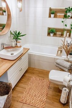 a bathroom with wooden floors and white walls