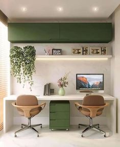 two chairs are sitting in front of a desk with a computer monitor and plant on it