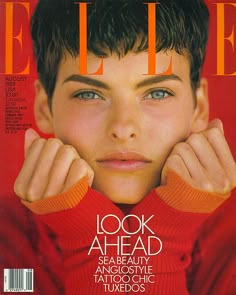 a magazine cover with an image of a young man wearing red sweaters and holding his hands on his head