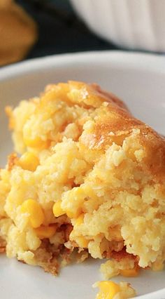 a close up of food on a plate with corn and bread crumbs in it