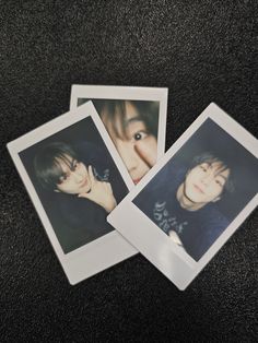 three polaroids are laying on the floor with one person's face in it