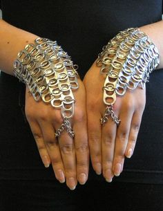 a woman is holding out her hands with chains on them