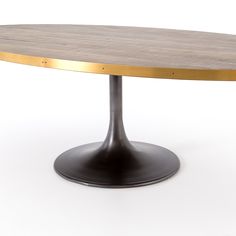 an oval wooden table with metal base on a white background