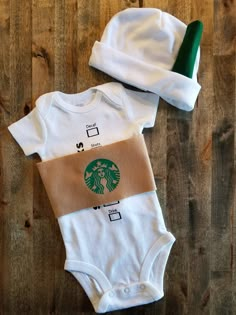 two baby onesuits with the starbucks logo on them, one has a green hat