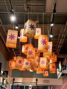 many paper lanterns are hanging from the ceiling