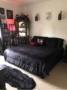 a bedroom with a black bed and lots of decor