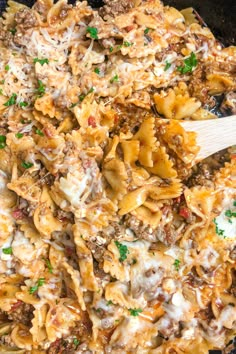 a skillet filled with pasta, meat and cheese