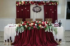 a table covered in red and white flowers