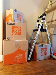 several boxes are stacked up on the floor next to a ladder