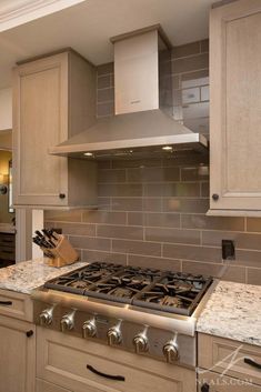 a stove top oven sitting inside of a kitchen