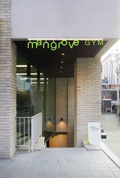 an entrance to a building with the name mango grove gym on it's side