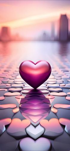 a heart shaped object sitting on top of water