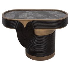 The Licol Side Table is a testament to the artistic finesse of R&Y Augousti, combining the raw beauty of black quartz with the organic elegance of rattan, all encased in a sophisticated bronze patina brass frame. The intricate rattan weaving encircles the table's base, providing a rich, textured contrast to the smooth, reflective surface of the black quartz top. Handcrafted to perfection, this piece is not merely a side table but a sculptural element that adds a touch of refined luxury to any sp Rattan Weaving, Brass Side Table, Bronze Patina, Black Quartz, Black Side Table, Raw Beauty, Reception Desk, Art Deco Inspired, White Quartz