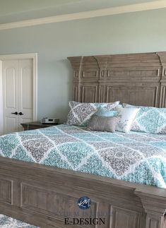 a bed with blue and white comforter in a bedroom