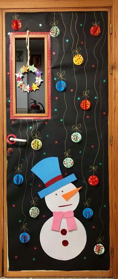 a door decorated with christmas decorations and a snowman's hat on the front