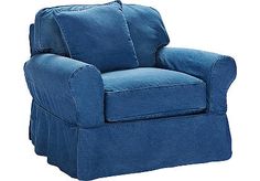 a blue chair with two pillows on the armrests and one pillow is folded over it