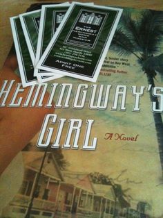 the front cover of a novel titled hemingaway's girl, which is being held by a hand