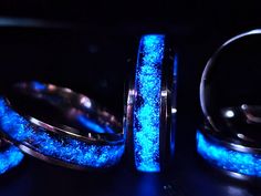 two rings with glowing blue glitter in the middle, and one ring on top of it