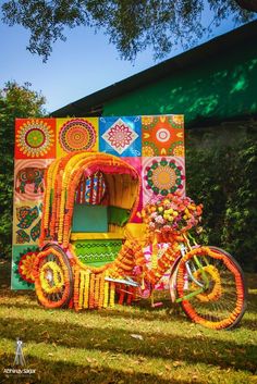 a colorfully decorated bike is parked in the grass