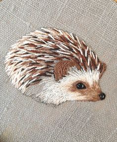 an embroidered hedge sitting on top of a piece of fabric