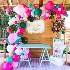 a table with some balloons on it and a sign that says cantala in front of it