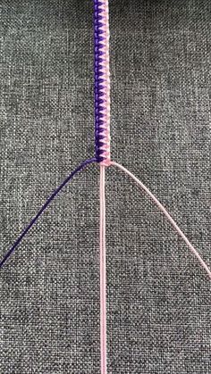 a close up of a purple object on a gray surface with wires attached to it