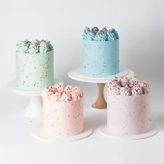 three cakes with sprinkles on them sitting on top of each other