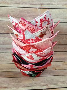 a stack of folded fabric sitting on top of a wooden floor