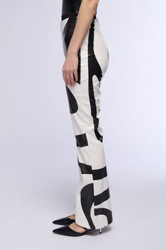 The AKIRA Label Groove On Faux Leather Flare Trouser is made from a slightly stretchy faux leather fabrication and features swirl print patterning, a high rise waist, and a flared leg silhouette. Complete with a tonal side zipper closure. Pair these groovy bottoms with a crop top and platform booties to finish off your dance floor-ready look! - 100% PU  - Little to No Stretch - Spot Clean Only  - Imported  (all measurements approximate from size small)  - 31” Inseam - 11.25“ Rise - Model height is 5’11.5” Product ID: 356529 (all measurements approximate from size 1X)  - 31.75” Inseam - 12.75“ Rise Product ID: 356533 Vintage Band Tees, Flare Trousers, Faux Leather Leggings, Leather Leggings, Band Tees, Ankle Booties, Swirl, High Rise, Crop Top