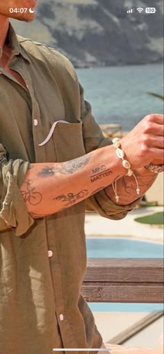 a man with tattoos on his arm and wrist