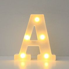 a light up letter sitting on top of a table