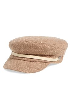 a tan hat with a ribbon on the side