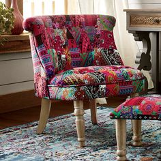 a colorful chair and ottoman in front of a window