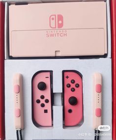 the nintendo switch is pink and has two controllers