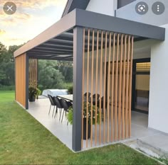 an outdoor patio with wooden slats on the roof and table set up for four