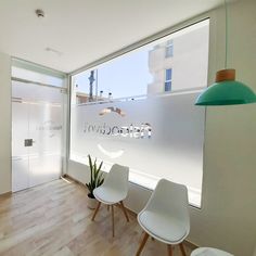 an office with two chairs and a plant in front of the glass wall that says sanctura