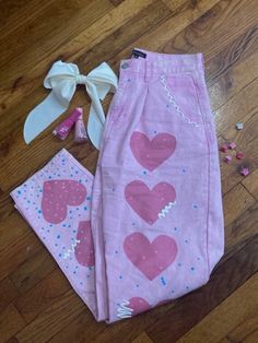 all Harmony Jean CO. jeans are thrifted and handpainted! custom, one of a kind designs on pink denim. 100% cotton, hand wash cold. hip: 46 waist: 29 length: 41 inseam: 29 Pink Heart Pants Outfit, Pink Patchwork Jeans, Jeans With Hearts On Them, Pink Heart Jeans, Pink Jeans With Hearts, Pink Y2k Denim Bottoms, Customizing Clothes, Heart Jeans, Upcycling Clothing