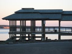 a wooden structure sitting next to the ocean