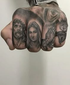 a hand with some tattoos on it