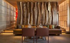 a living room filled with furniture and walls covered in wood planks on the wall