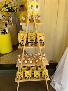 a yellow and white dessert stand with cupcakes on it