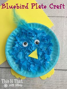 a paper plate bird with blue feathers on it and the words bluebird plate craft