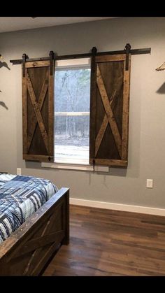 a bedroom with a bed and two wooden barn doors