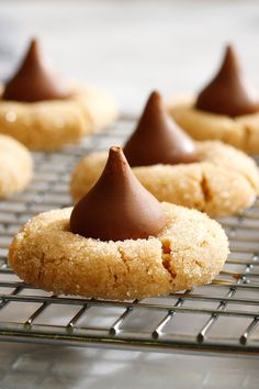 some cookies with chocolate on top sitting on a cooling rack