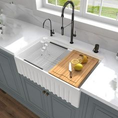 a kitchen sink with a cutting board and lemons on the counter next to it