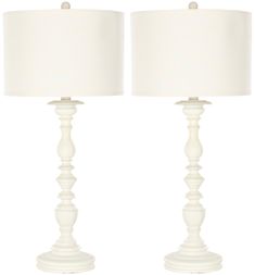 a pair of white table lamps sitting next to each other