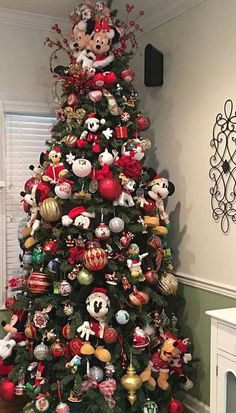 a christmas tree decorated with mickey mouse ornaments