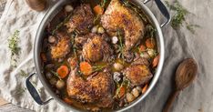 a pot filled with chicken and vegetables on top of a table