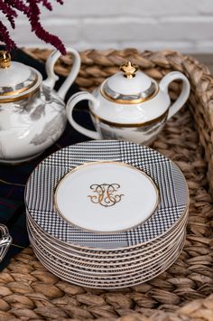 a basket filled with plates and cups on top of a table